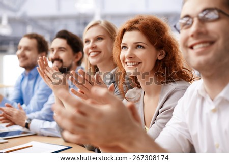 Group of business partners applauding at conference