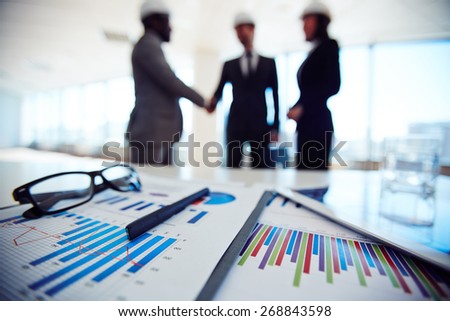 Business documents on background of three business partners