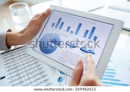 Marketing data in digital tablet and female hand over it