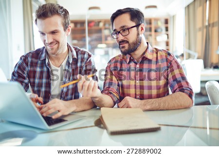 Asian businessman explaining data to his colleague at meeting