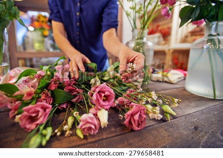 Female florist sorting flowers in workshop