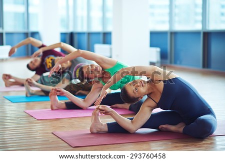 Several sporty people making stretching exercise
