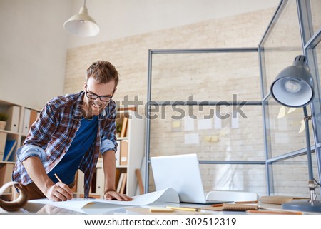Modern architect with pencil drawing sketch of construction in office