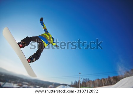 Man on snowboard enjoying extreme kind of sport on winter resort