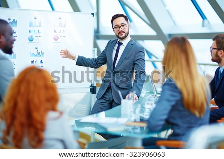 Asian businessman presenting review of financial data to colleagues
