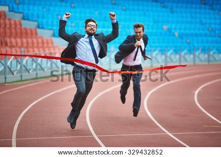 Successful young businessman winning the race