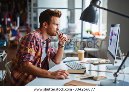 Modern designer sitting in front of computer in office
