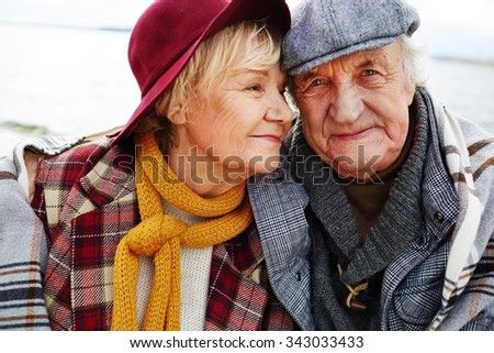 Affectionate senior couple in warm clothes