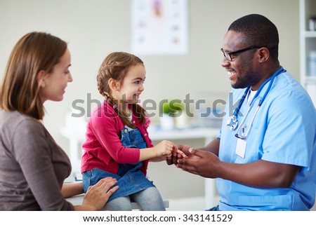 Cute child and doctor talking in clinics