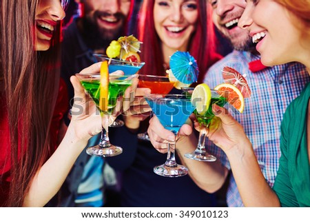 Young people having fun at party with cocktails