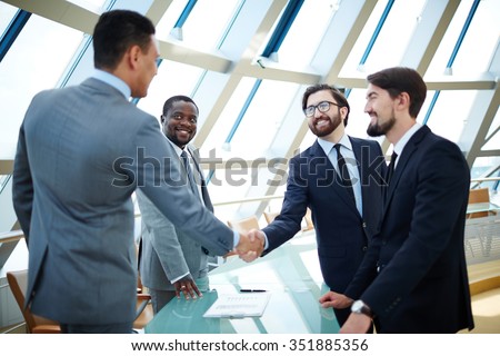 Businessmen shaking hands to confirm a deal
