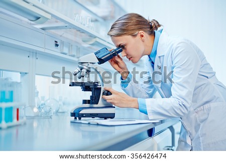 Pretty scientist studying new virus in laboratory