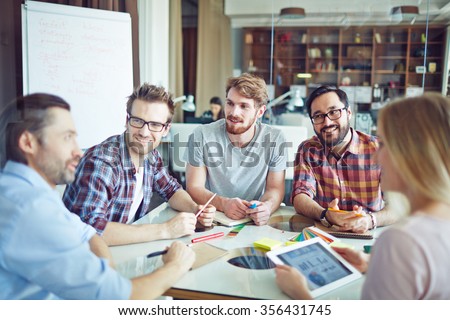 Group of modern employees discussing their working ideas
