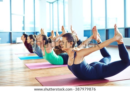 Group of young people relaxing and practicing in yoga