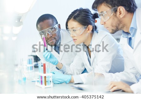 Group of scientists studying reaction of some chemical