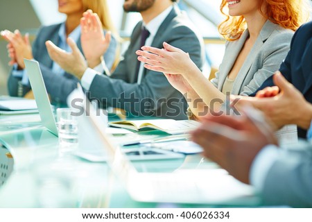 Business people clapping at conference