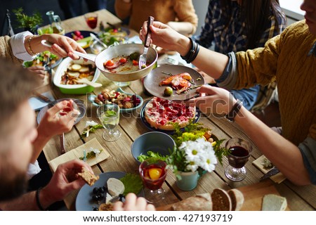People sitting at dining table and eating