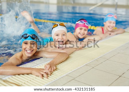 Happy group of children swimming together