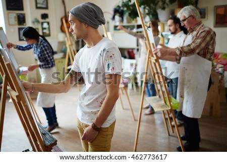 Group of students painting at art lessons