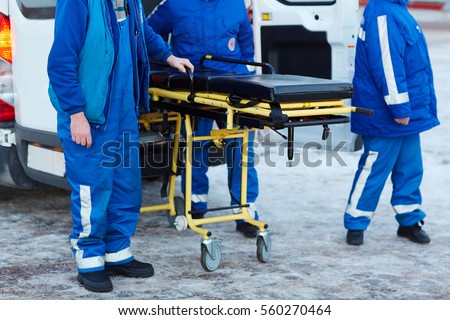 Emergency ambulance workers with stretcher