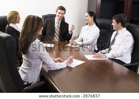 Team of successful business people are sitting at the table and discussing