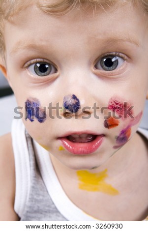 Isolated on white curly boy in gray t-shirt with painted face