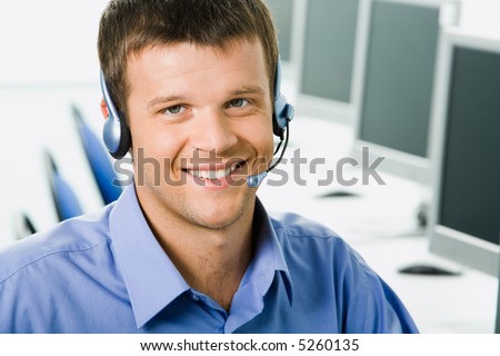 Friendly telephone operator smiling during a telephone conversation