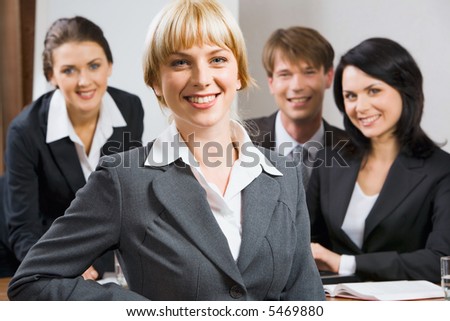 Female leader on the background of  her business team