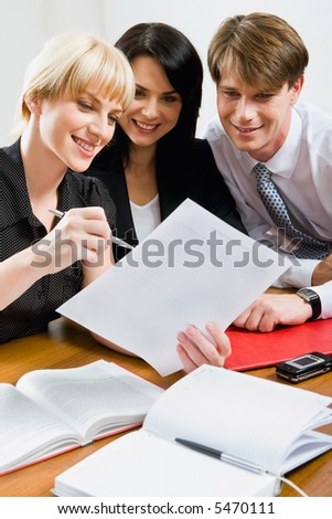Confident businesswomen is showing research results to her co-workers in the office
