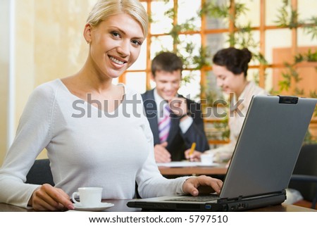 Portrait of pretty business woman in the white blouse in the cafe
