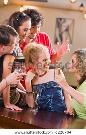 Image of  an interaction of young happy people in a bar