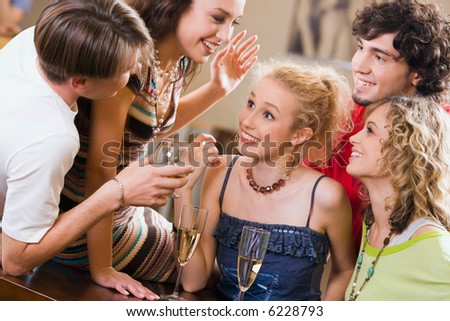 Young people are chatting at an evening-party