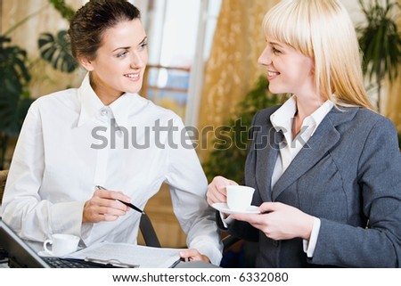 Portrait of  two contemporary businesspeople at a meeting in a cafe
