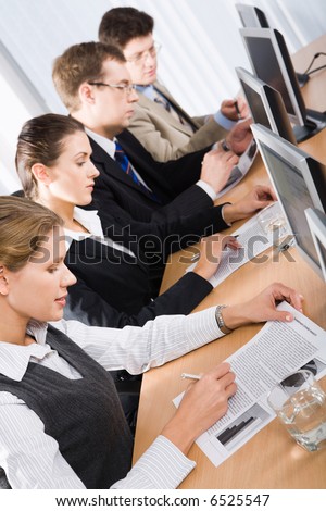 Mature students studying an educational material at training