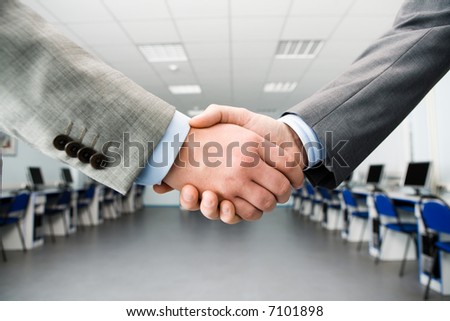 Image of shaking hands making an agreement in the classroom