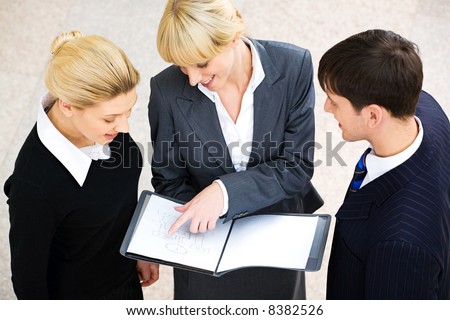 Portrait of confident woman demonstrating her project to business people at meeting