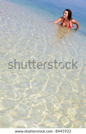 Image of happy pretty woman swimming in a lake