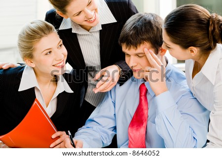 Three business ladies smiling at the thinking man