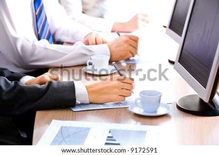 Image of line of human hands lying on the table at business training