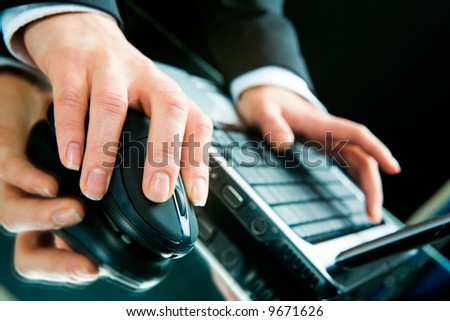 Photo of hands typing a letter on the laptop