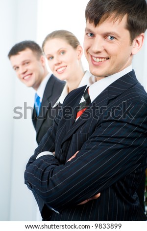 Row of successful business team with leader in front