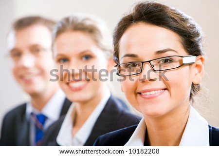 Row of business people with clever woman in front