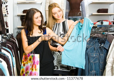 Two friends looking at new T-shirt and choosing new clothes