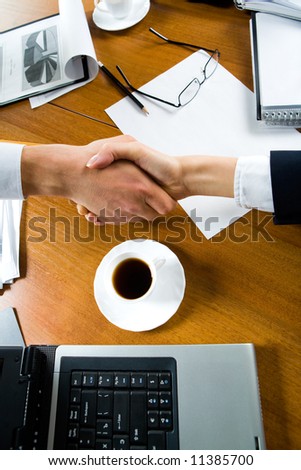 Close-up of people making a deal with a handshake