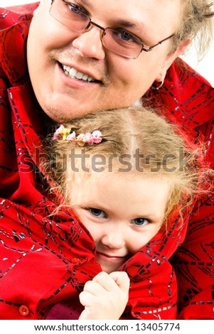 Close-up of happy man in glasses with small daughter looking out of his shirt