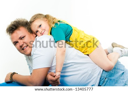 Image of small girl lying on her father’s back over white background