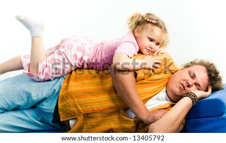 Portrait of father and his daughter lying on the bad