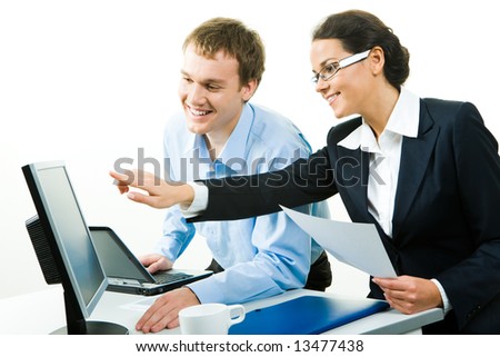 View of businesswoman pointing at computer explaining business-plan to her colleague