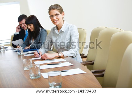 Photo of student sitting at the table at business conference