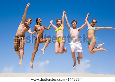 stock photo : Joyful team of friends holding for hands each other and 